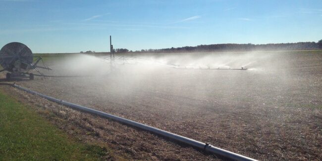 Irrigazione agricola immagine di campo agricolo con irrigatore ali piovane in azione